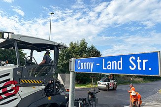 Foto vom Strassenschild Conny-Land Strasse mit STRABAG Fertiger